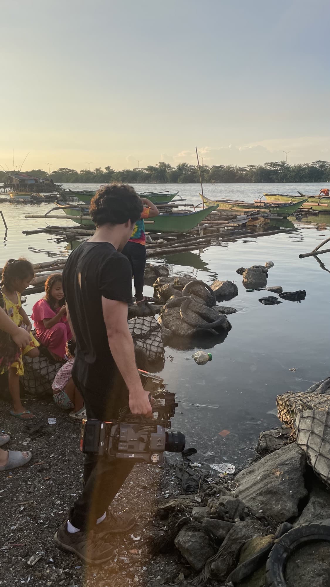 Antonio Mendes filming on location by the water